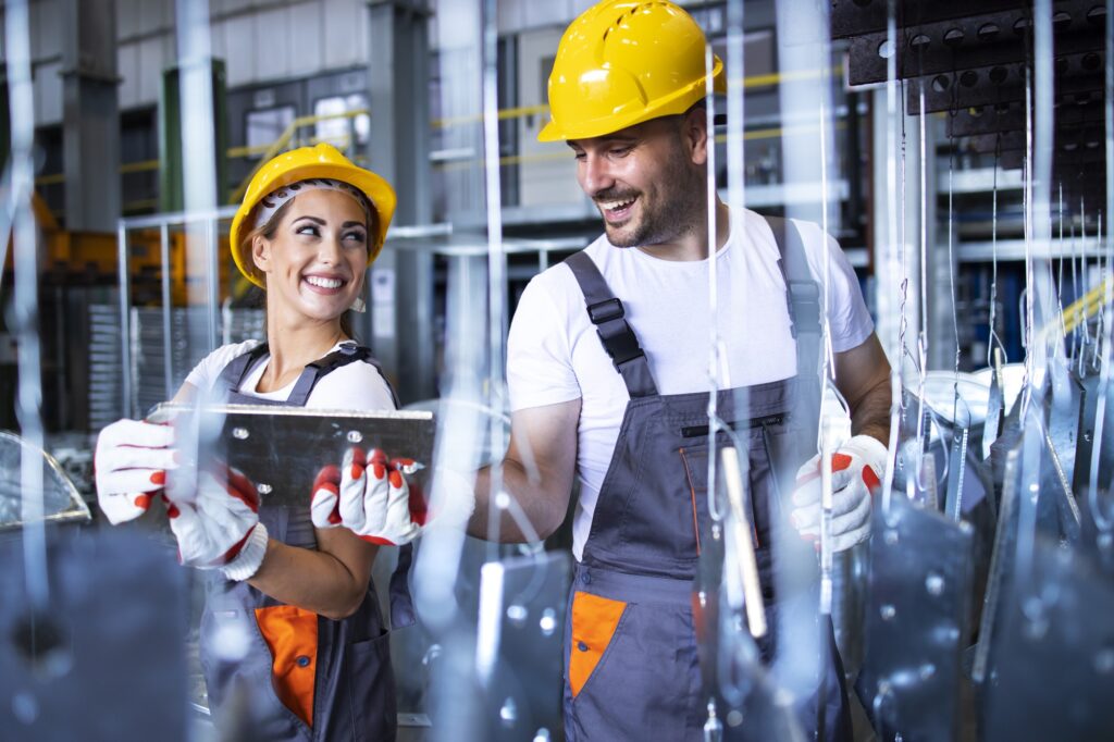 factory-workers-working-together-industrial-metal-production-line